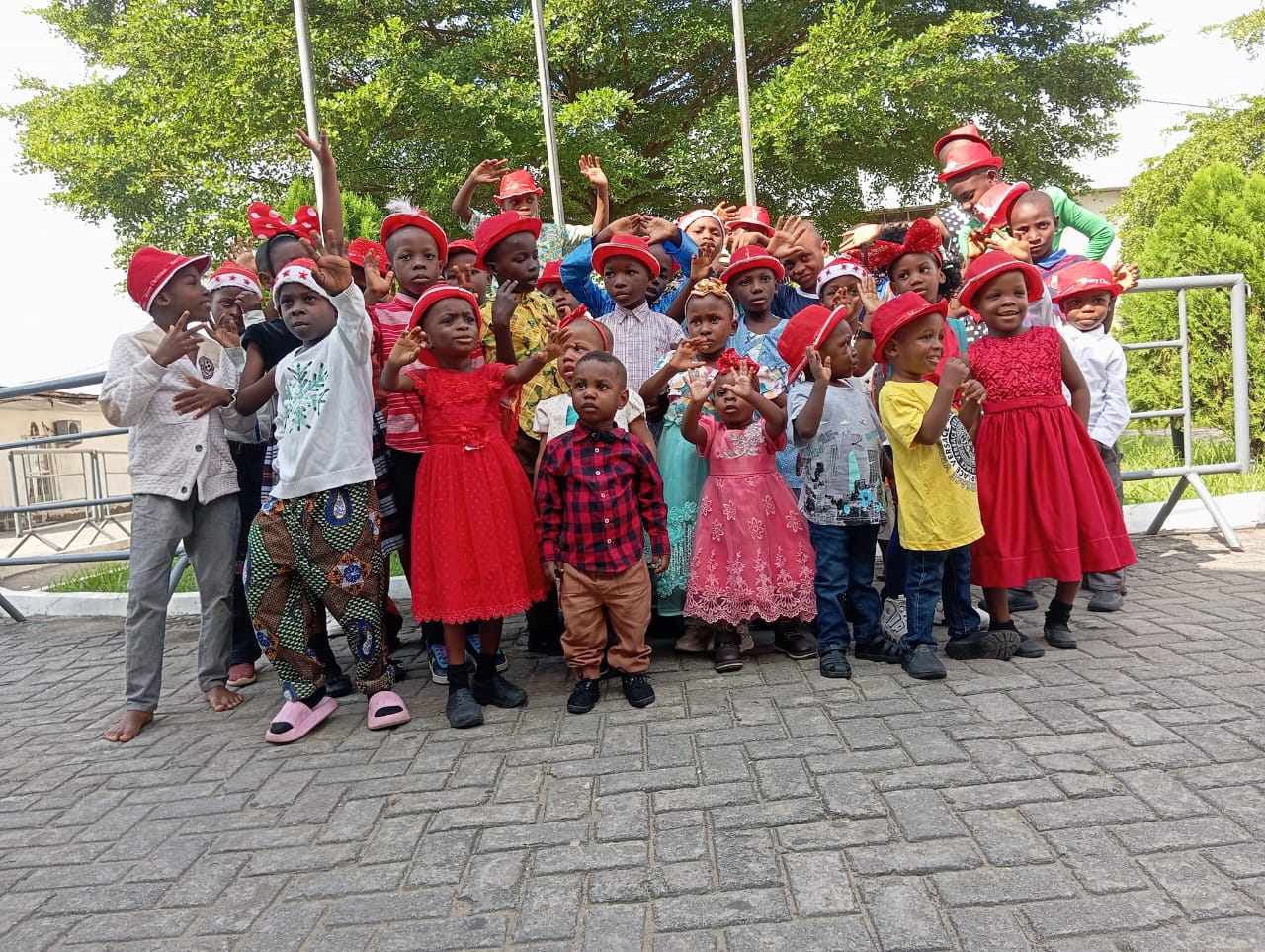 Children in school uniform gathered outside the home